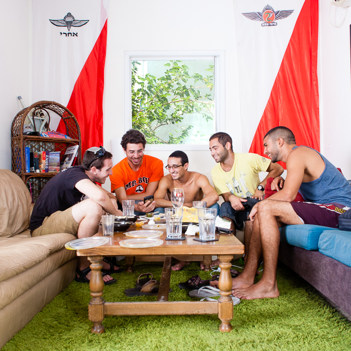 Friday morning. Alex enjoys shwarma at home with friends from his unit before heading to the beach.