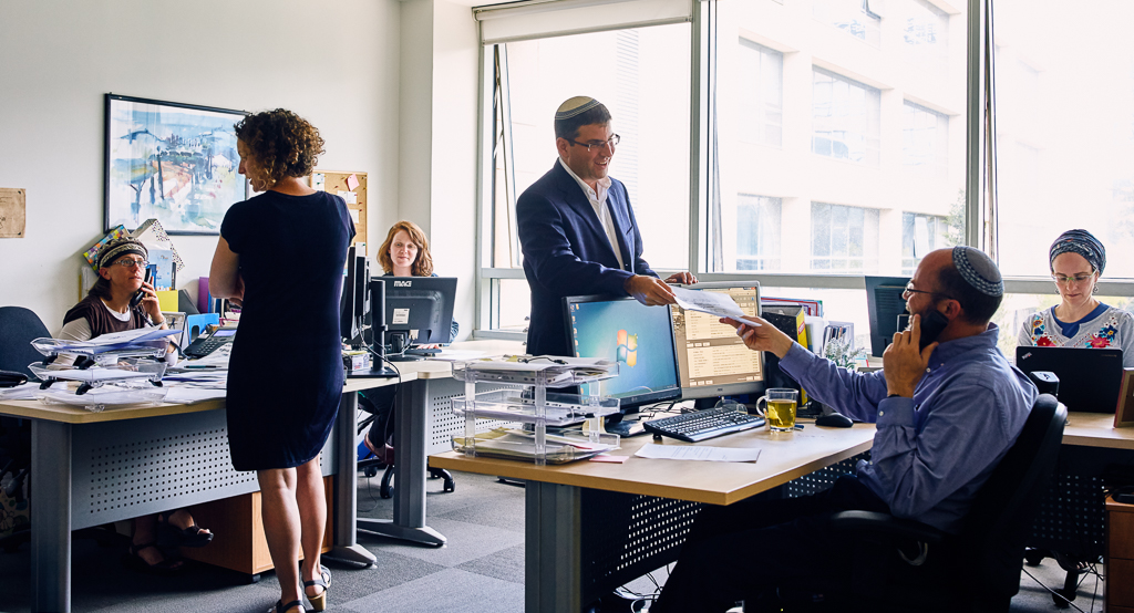 Rabbi Farber at work with his team at Itim in Jerusalem. The organization helps Israelis navigate the bureaucracy of religious authorities and has touched the lives of hundreds of thousands. Bonei Zion Prize for Community & Non-Profit, 2015.
